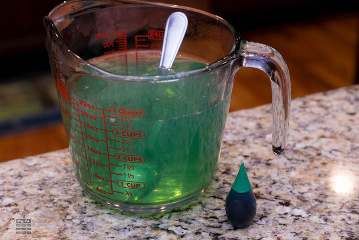 Add a drop of green food coloring and stir