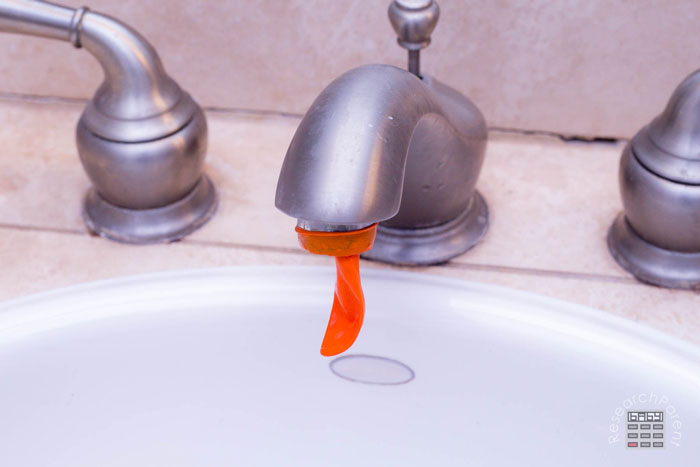 Put water balloon on faucet